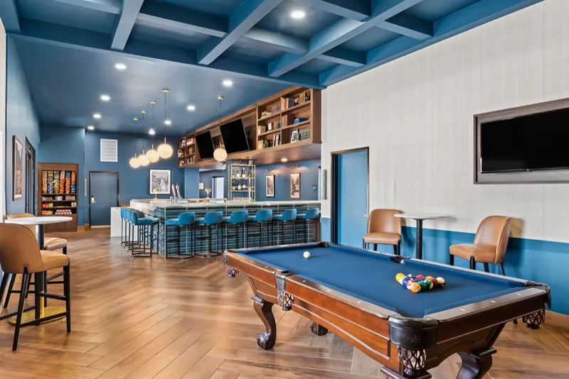 The Ellsworth Hotel lounge, with a pool table, a long bar and blue beamed ceilings